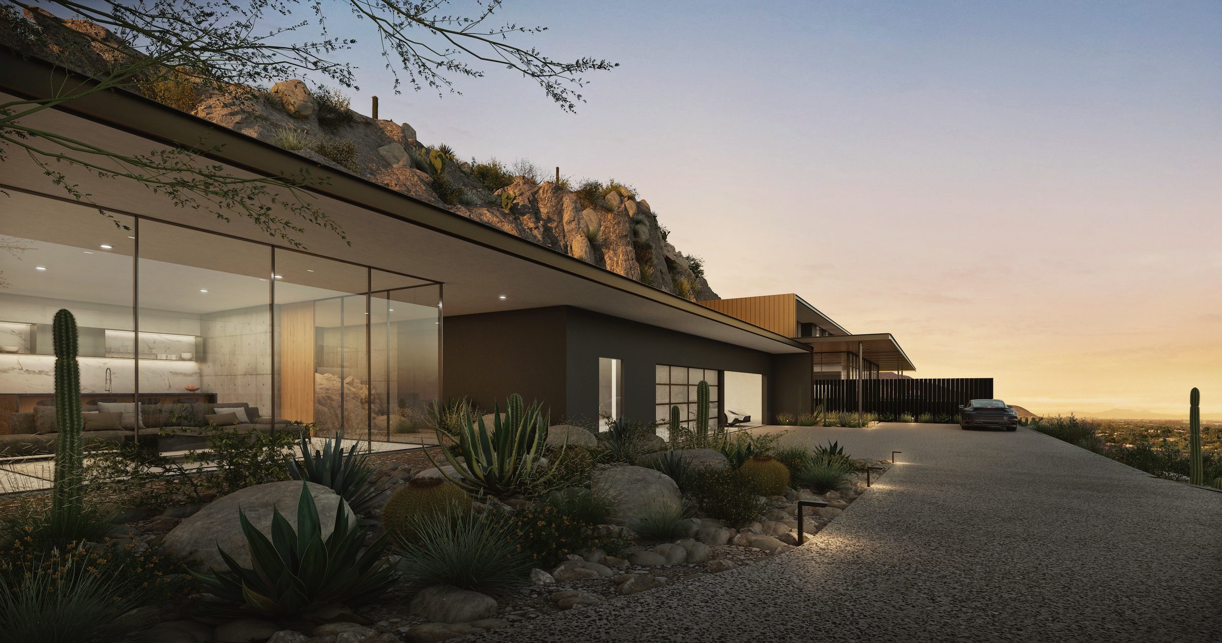 Architectural exterior at sunset with carved hillside backdrop